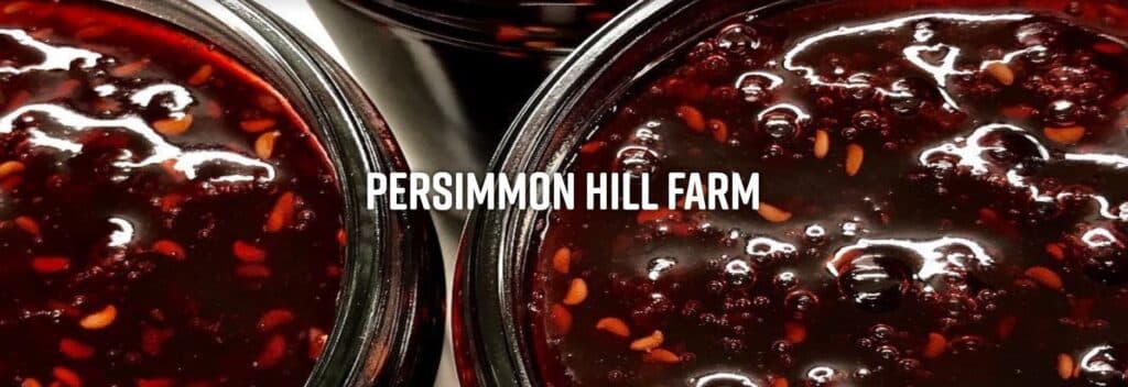 A close-up of jars filled with dark fruit preserve from Persimmon Hill Farm.