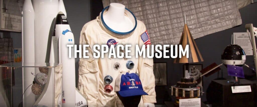 Display of an astronaut suit and space artifacts at The Space Museum.