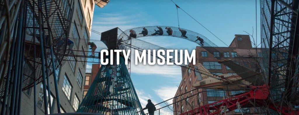 A view of the City Museum featuring playful structures and visitors exploring outdoor installations.