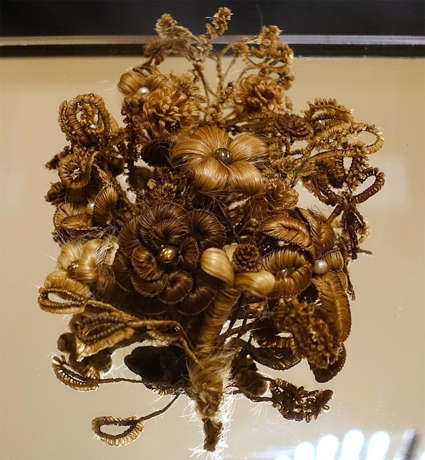 A decorative arrangement of intricately crafted brown flowers made from twisted materials.