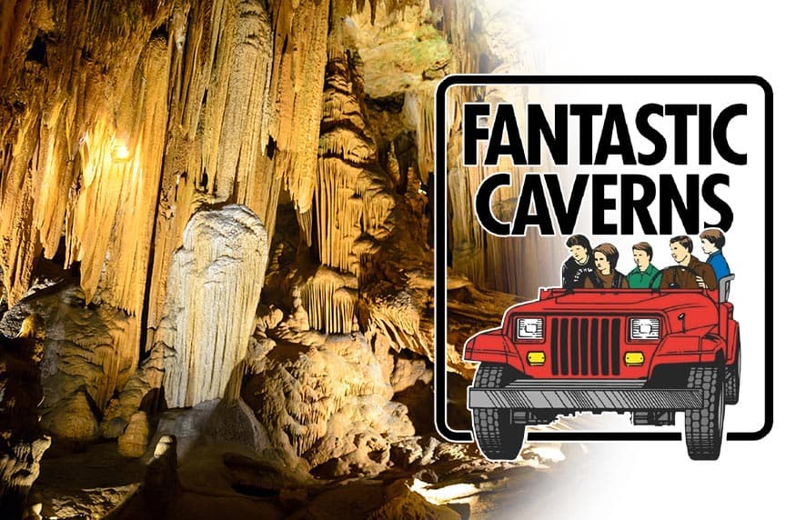 A beautifully lit cave interior with stalactites and a logo for "Fantastic Caverns" featuring a red jeep and visitors.